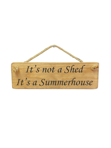 30cm x 10cm, Solid wood decorative garden sign, handmade in the UK by Austin Sloan with a humorous shed quote "It's not a shed It's a summerhouse" in a natural wood colour
