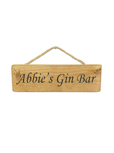 30cm x 10cm, solid wood decorative personalised bar sign, handmade in the UK by Austin Sloan with a Personalised alcohol lovers quote "Abbie's Gin Bar" in a natural wood colour