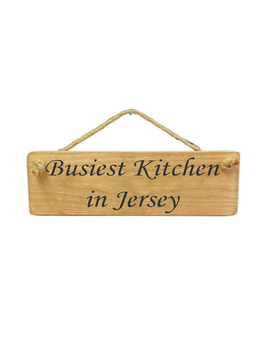 30cm x 10cm, Solid wood decorative personalised kitchen sign, handmade in the UK by Austin Sloan with a Personalised kitchen quote "Busiest kitchen in Personalised Area" in a natural wood colour