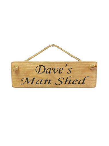 30cm x 10cm, solid wood decorative personalised shed sign, handmade in the UK by Austin Sloan with a personalised Man shed quote "Dave's Man Shed" in a natural wood colour