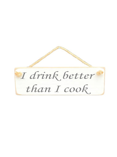 30cm x 10cm, Solid wood decorative kitchen sign, handmade in UK by Austin Sloan with a humorous quote "I drink better than I cook" in antique white colour