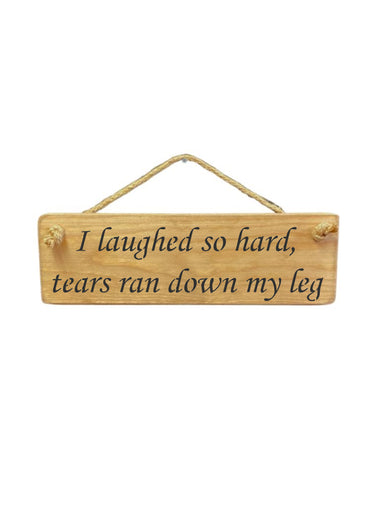 30cm x 10cm, Solid wood decorative home sign, handmade in the UK by Austin Sloan with a humorous quote "I laughed so hard, tears ran down my leg" in natural wood colour.
