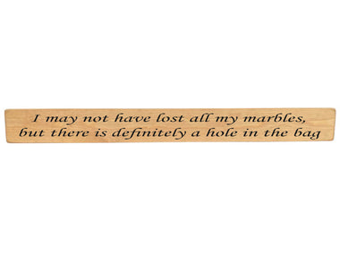 90cm x 10cm, Solid wood decorative home sign, handmade in the UK by Austin Sloan with a humorous quote "I may not have lost all my marbles, but there is definitely a hole in the bag" Natural wood with black wording