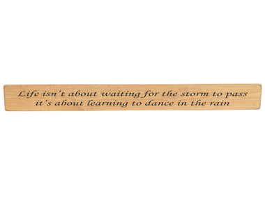 90cm x 10cm, Solid wood decorative home sign, handmade in the UK by Austin Sloan with a inspirational quote "Life isn't about waiting for the storm to pass" Natural wood with black wording