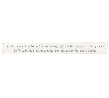 90cm x 10cm, Solid wood decorative home sign, handmade in the UK by Austin Sloan with a inspirational quote "Life isn't about waiting for the storm to pass" Antique white wood with black wording