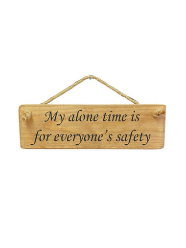 30cm x 10cm, solid wood decorative home sign, handmade in the UK by Austin Sloan with a humorous quote "My alone time is for everyone's safety" in a natural wood colour