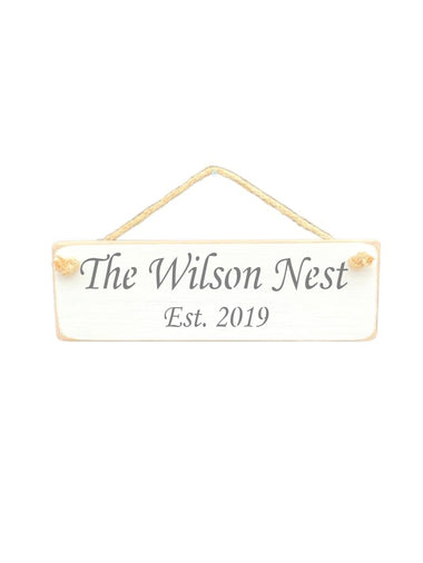 30cm x 10cm, solid wood decorative personalised house sign, handmade in the UK by Austin Sloan with a personalised quote "The Wilson Nest Est. 2019" in a antique white colour