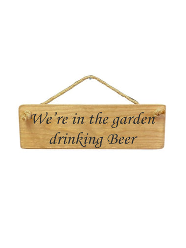 30cm x 10cm, Solid wood decorative garden sign, handmade in the UK by Austin Sloan with a alcohol lovers quote "We're in the garden drinking Beer" in a natural wood colour