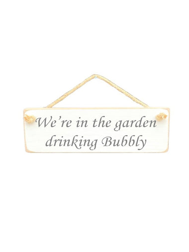 30cm x 10cm, Solid wood decorative garden sign, handmade in the UK by Austin Sloan with a alcohol lovers quote "We're in the garden drinking Bubbly" in a antique white colour