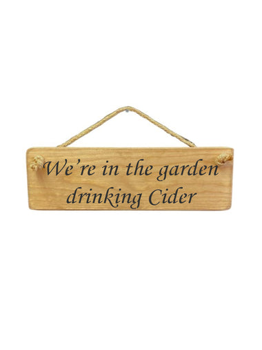 30cm x 10cm, Solid wood decorative garden sign, handmade in the UK by Austin Sloan with a alcohol lovers quote "We're in the garden drinking Cider" in a natural wood colour