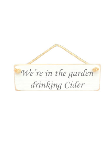 30cm x 10cm, Solid wood decorative garden sign, handmade in the UK by Austin Sloan with a alcohol lovers quote "We're in the garden drinking Cider" in a antique white colour