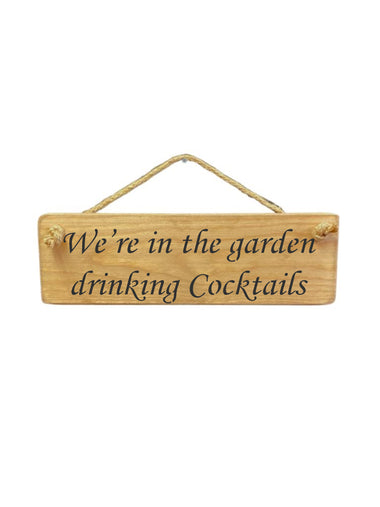 30cm x 10cm, Solid wood decorative garden sign, handmade in the UK by Austin Sloan with a alcohol lovers quote "We're in the garden drinking Cocktails" in a natural wood colour