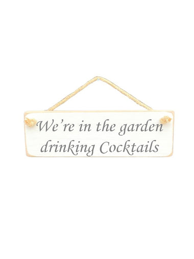 30cm x 10cm, Solid wood decorative garden sign, handmade in the UK by Austin Sloan with a alcohol lovers quote "We're in the garden drinking Cocktails" in a antique white colour