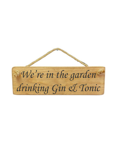 30cm x 10cm, solid wood decorative gin lovers sign, handmade in the UK by Austin Sloan with a garden quote "We're in the garden drinking Gin & Tonic" in a natural wood colour
