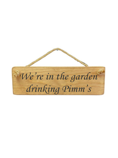 30cm x 10cm, Solid wood decorative garden sign, handmade in the UK by Austin Sloan with a alcohol lovers quote "We're in the garden drinking Pimm's" in a natural wood colour