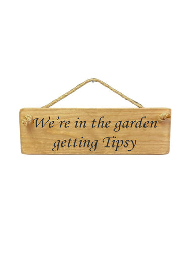 30cm x 10cm, Solid wood decorative garden sign, handmade in the UK by Austin Sloan with a alcohol lovers quote "We're in the garden getting Tipsy" in a natural wood colour