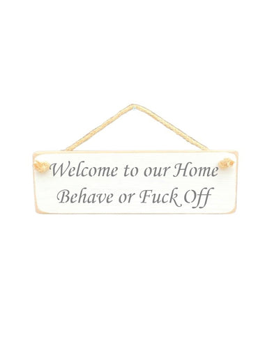 30cm x 10cm, Solid wood decorative home sign, handmade in the UK by Austin Sloan with a humorous quote "Welcome to our Home Behave or Fuck Off" in a antique white colour