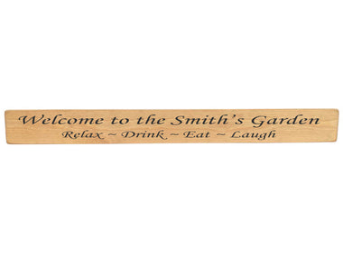 90cm x 10cm, Solid wood decorative garden sign, handmade in the UK by Austin Sloan with a personalised garden quote "Welcome to the Smith's Garden Relax ~ Drink ~ Eat ~ Laugh" Natural wood with black wording